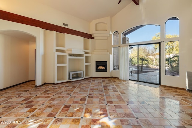 unfurnished living room featuring high vaulted ceiling