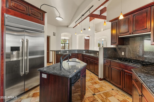 kitchen featuring sink, appliances with stainless steel finishes, a center island, tasteful backsplash, and decorative light fixtures