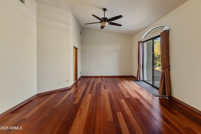 spare room featuring vaulted ceiling, dark hardwood / wood-style floors, and ceiling fan