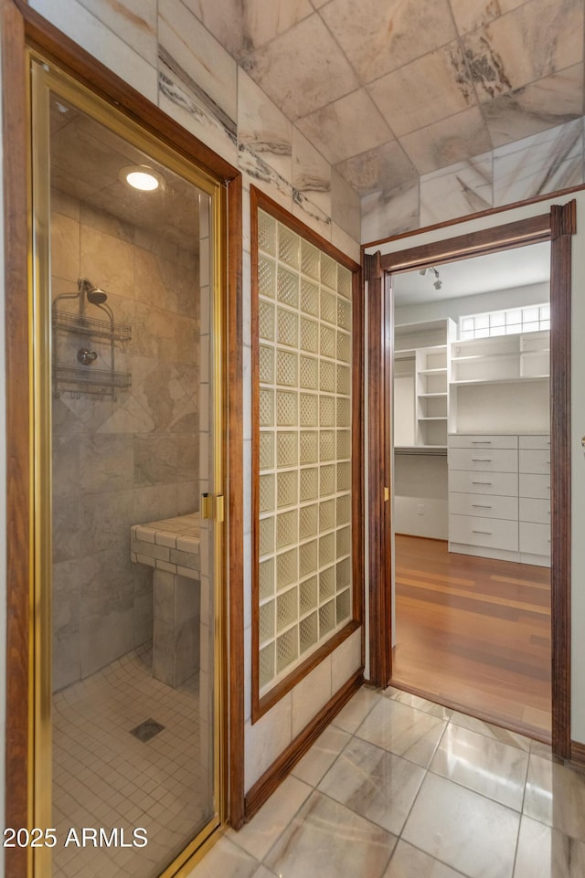 bathroom featuring a shower with door