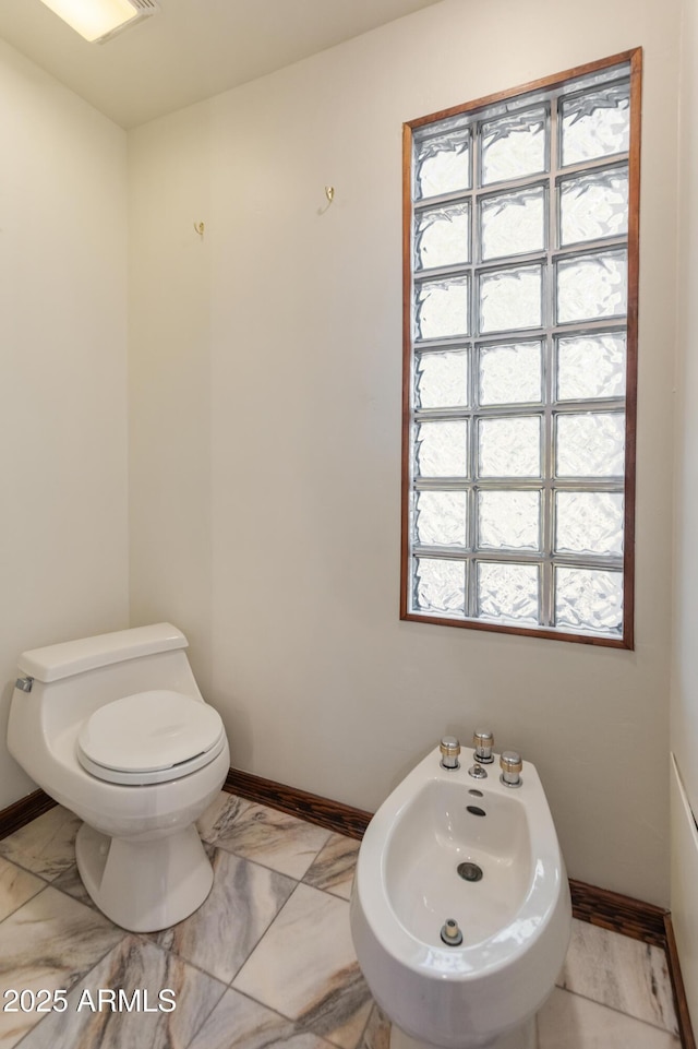 bathroom with a bidet and toilet