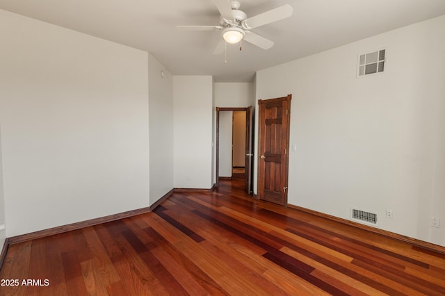 spare room featuring dark hardwood / wood-style floors and ceiling fan