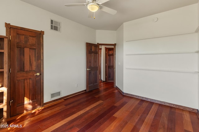 unfurnished bedroom featuring ceiling fan and dark hardwood / wood-style flooring