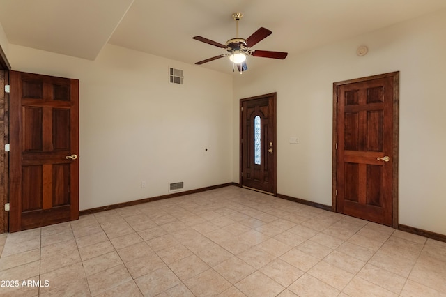 unfurnished room with light tile patterned flooring and ceiling fan