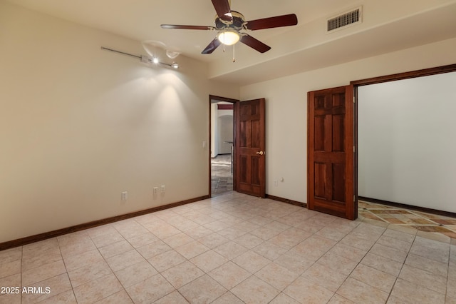 unfurnished bedroom with light tile patterned floors and ceiling fan