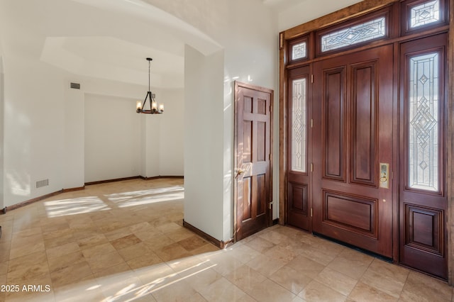 entrance foyer with a chandelier