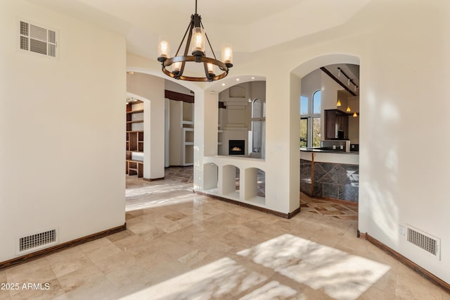 unfurnished dining area with a chandelier