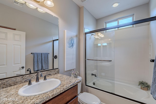 full bath with toilet, combined bath / shower with glass door, vanity, and visible vents