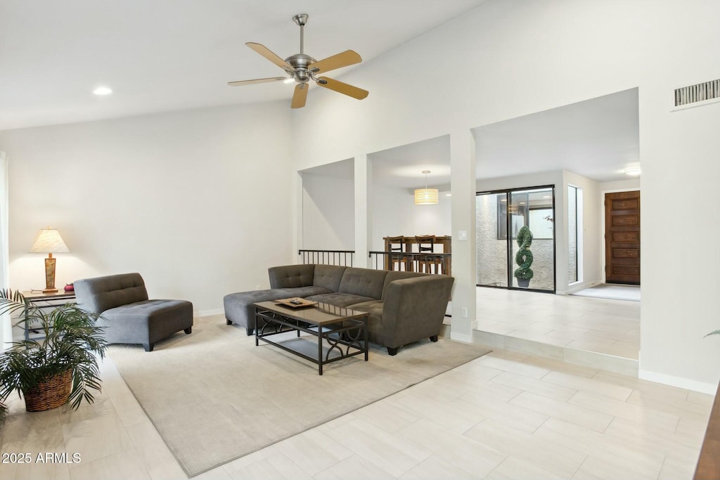 living room with ceiling fan and high vaulted ceiling