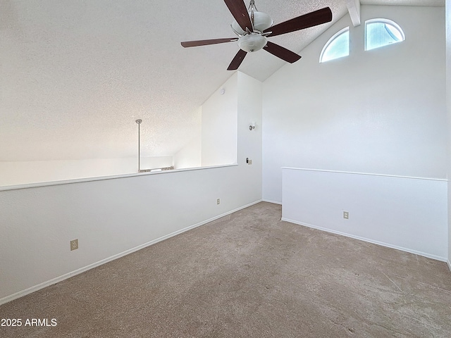 spare room with vaulted ceiling, light carpet, ceiling fan, and a textured ceiling