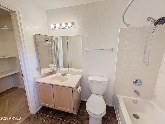 full bathroom with tile patterned flooring, vanity, toilet, and tiled shower / bath