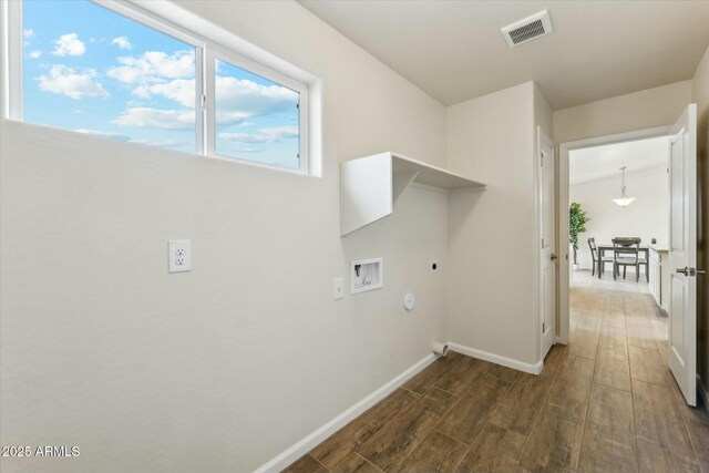 laundry room with washer hookup, dark wood finished floors, visible vents, electric dryer hookup, and laundry area