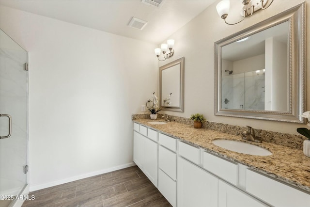 full bath with wood tiled floor, a sink, and a shower stall