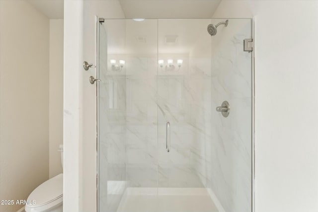 full bath with toilet and a marble finish shower