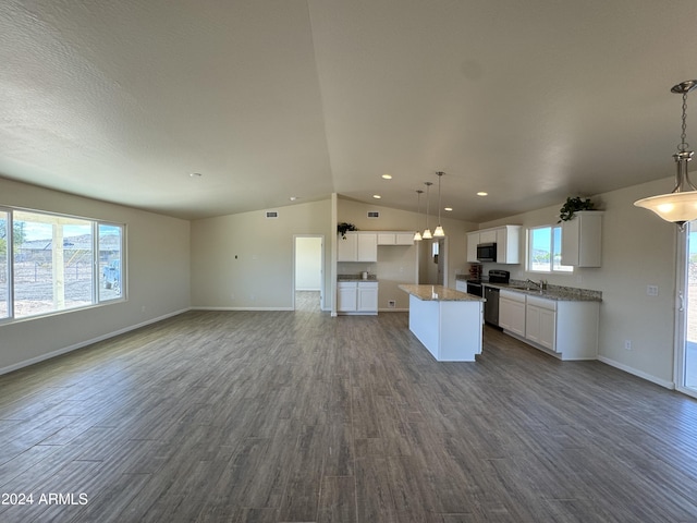 kitchen featuring lofted ceiling, range, open floor plan, and dark wood-style flooring