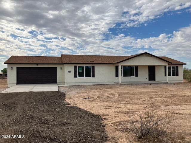 single story home featuring an attached garage and driveway