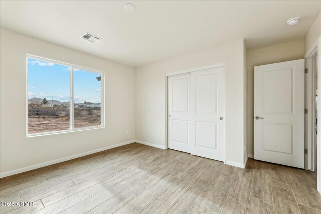 bathroom featuring a stall shower, wood tiled floor, visible vents, and a sink