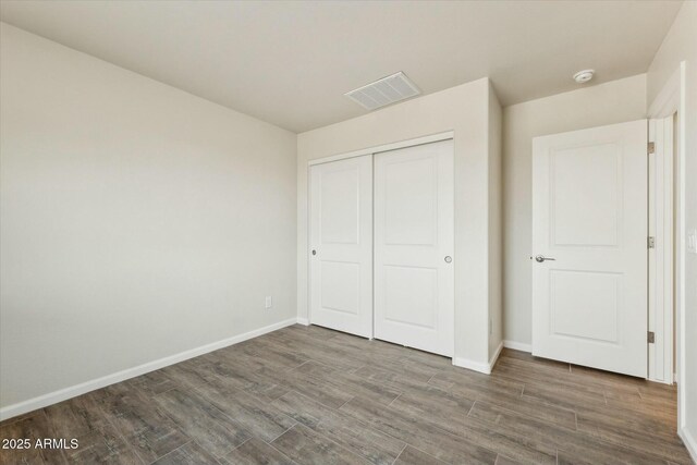 bathroom with double vanity, a sink, baseboards, and wood finished floors