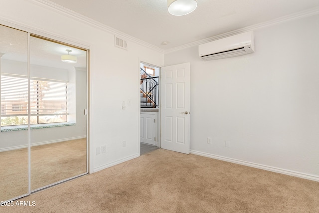 unfurnished bedroom with carpet floors, visible vents, crown molding, and a wall mounted air conditioner