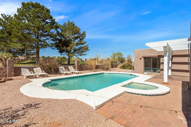 view of swimming pool with a patio area, a pool with connected hot tub, and fence