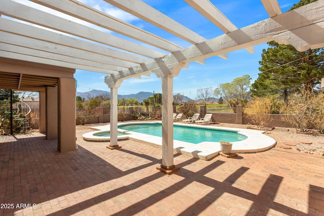 view of pool featuring a fenced backyard, a patio area, a pool with connected hot tub, a mountain view, and a pergola