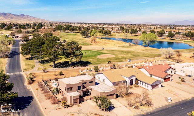 bird's eye view featuring view of golf course, a residential view, and a water and mountain view