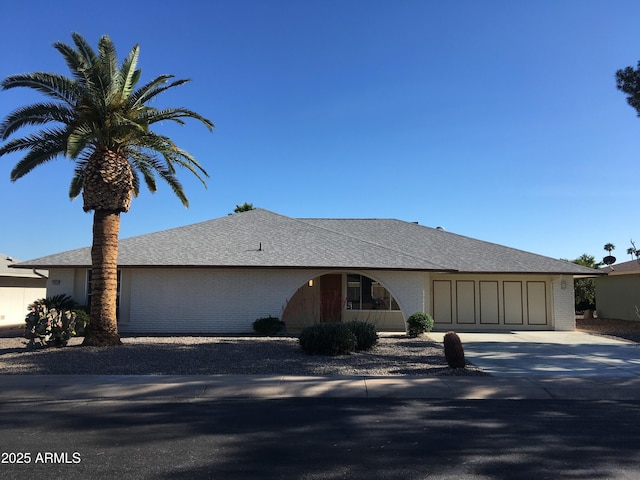 12919 W Beechwood Dr, Sun City West, AZ 85375 - ranch-style house featuring an attached garage, concrete driveway, brick siding, and roof with shingles