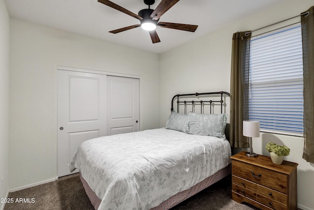 carpeted bedroom with baseboards, a ceiling fan, and a closet