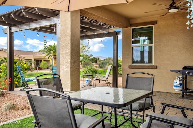 view of patio / terrace with a ceiling fan, a pergola, and outdoor dining space