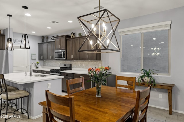 dining space with light tile patterned floors, recessed lighting, visible vents, and an inviting chandelier