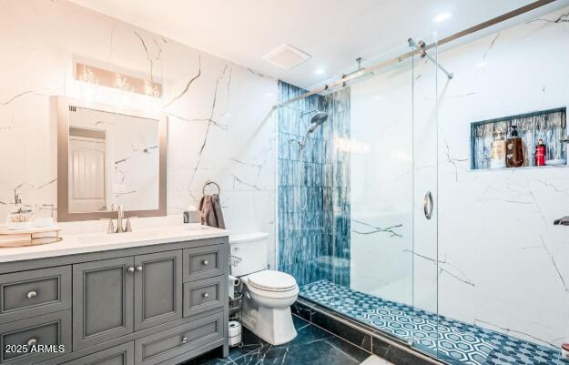 11215 N 37th Ave, Phoenix, AZ 85029 - bathroom with a marble finish shower, vanity, toilet, and tile walls