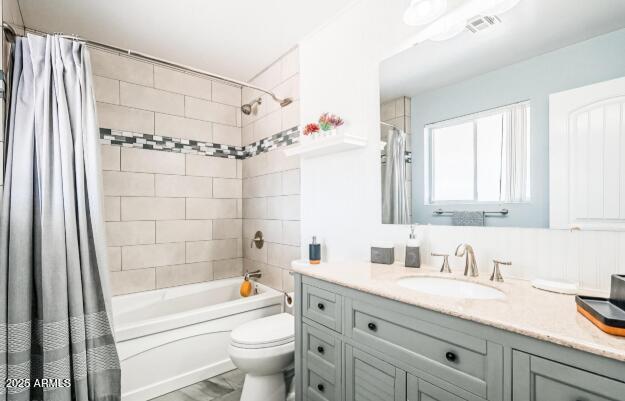 11215 N 37th Ave, Phoenix, AZ 85029 - bathroom featuring vanity, shower / bath combo with shower curtain, and toilet