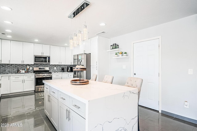 11215 N 37th Ave, Phoenix, AZ 85029 - kitchen with stainless steel appliances, recessed lighting, decorative backsplash, white cabinetry, and a center island