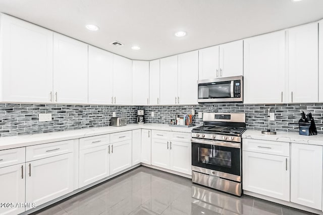 11215 N 37th Ave, Phoenix, AZ 85029 - kitchen featuring stainless steel appliances, backsplash, recessed lighting, and white cabinetry