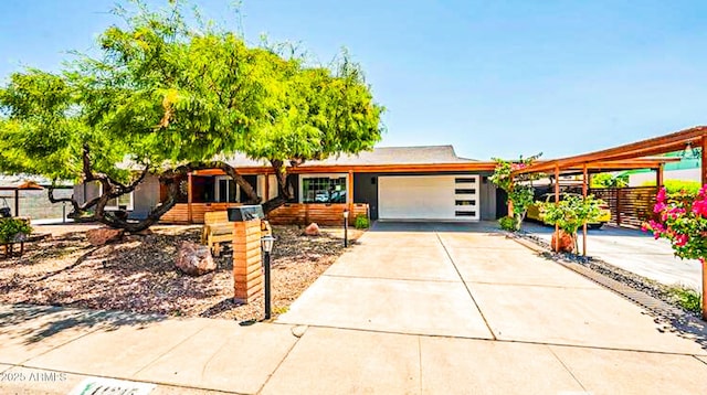 11215 N 37th Ave, Phoenix, AZ 85029 - view of front of home with an attached garage, concrete driveway, and a carport