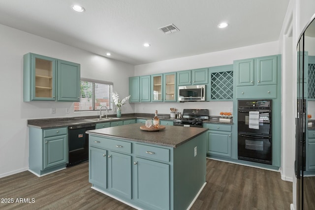 kitchen featuring a center island, sink, dark hardwood / wood-style floors, and black appliances