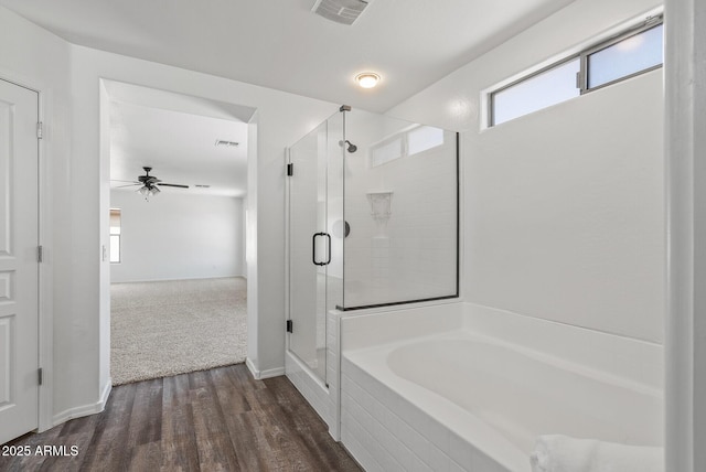 bathroom featuring hardwood / wood-style flooring, plus walk in shower, and ceiling fan