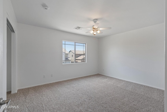 empty room featuring carpet floors and ceiling fan