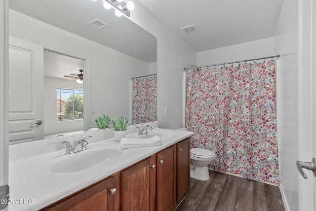 bathroom with hardwood / wood-style flooring, vanity, and toilet