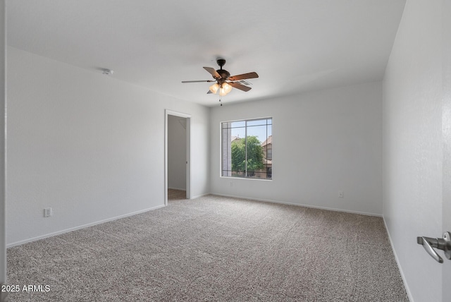 spare room with ceiling fan and carpet