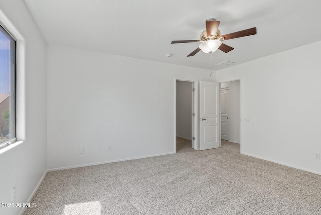 unfurnished bedroom featuring ceiling fan and light colored carpet