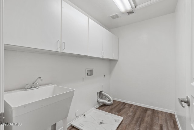 clothes washing area with sink, cabinets, hookup for a gas dryer, hookup for a washing machine, and electric dryer hookup