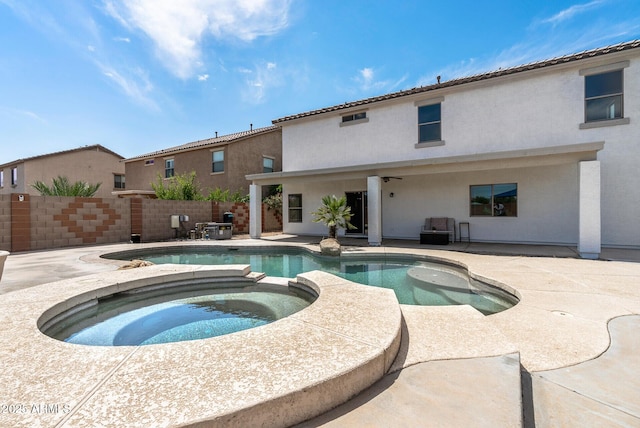 view of swimming pool featuring an in ground hot tub and a patio