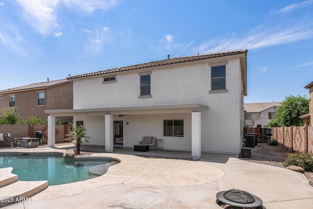 back of house with central AC unit, a patio, a fenced in pool, and an outdoor fire pit