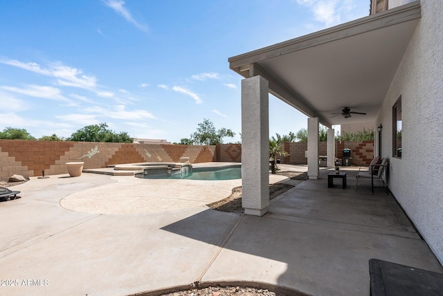 view of patio with ceiling fan and a pool with hot tub