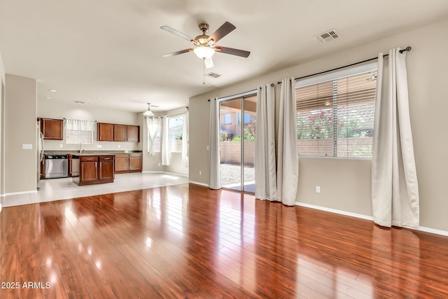 121 W Hackberry Dr, Chandler, AZ 85248 - unfurnished living room with a ceiling fan, baseboards, and a sink