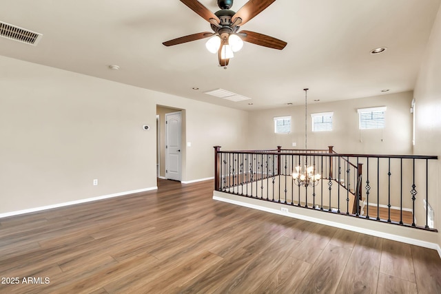 121 W Hackberry Dr, Chandler, AZ 85248 - spare room featuring wood finished floors, ceiling fan, a chandelier, baseboards, and recessed lighting