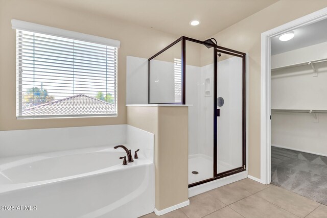 121 W Hackberry Dr, Chandler, AZ 85248 - full bath featuring tile patterned flooring, a shower stall, a bath, a walk in closet, and baseboards