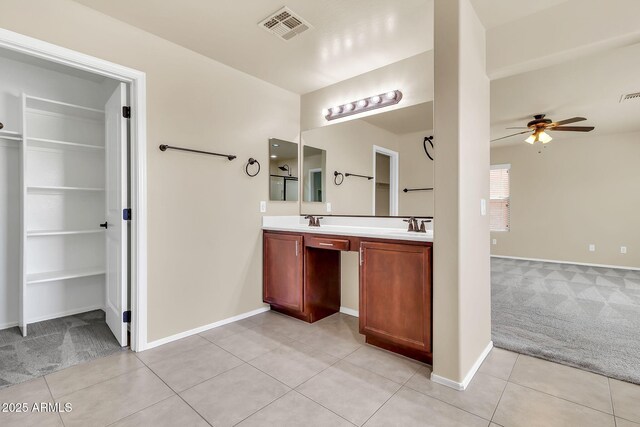 121 W Hackberry Dr, Chandler, AZ 85248 - bathroom with ceiling fan, tile patterned flooring, double vanity, a walk in closet, and baseboards