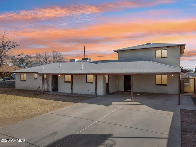 view of front facade with driveway and brick siding